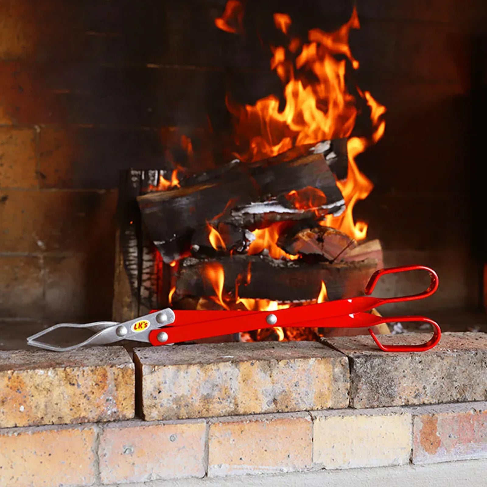 Aluminium Barbecue Tongs with Fireplace in the Background